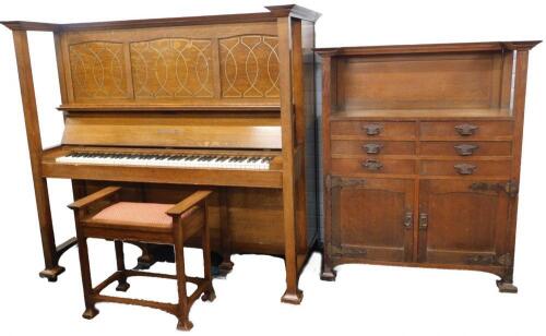 A late 19th/early 20thC arts and crafts style oak upright piano