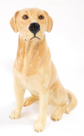 A Beswick pottery fireside model of a seated labrador retriever