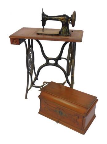 A Singer walnut and cast iron treadle sewing machine