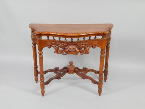 A Continental walnut serpentine side table