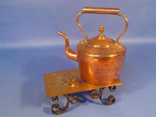 A Victorian copper kettle with acorn finial and a brass and iron footman