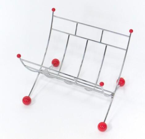 A folding metal Atomic magazine rack