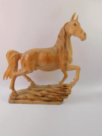 A modern wooden carving of a prancing horse