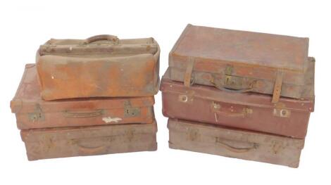 Four leather bound vintage suitcases