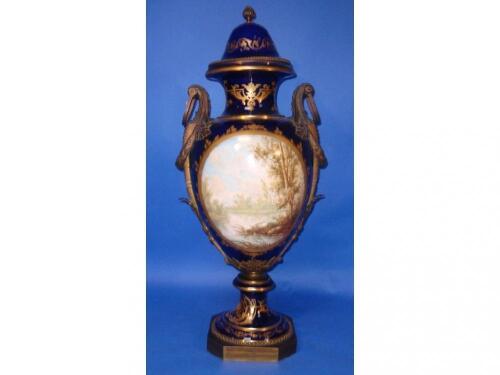 A Sevres style urn with bronze handles and mounts