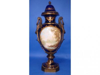 A Sevres style urn with bronze handles and mounts