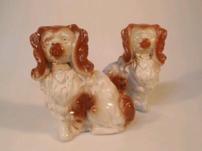 A pair of pottery comforter dogs in the form of King Charles spaniels