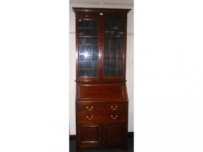 An Edwardian chevron string inlaid mahogany bureau bookcase