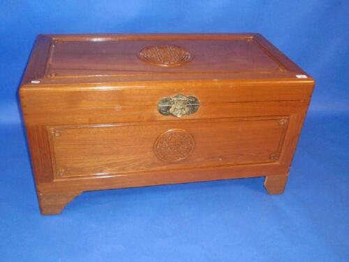 A carved camphorwood blanket chest