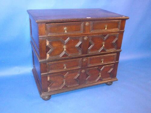 A Jacobean style oak chest of four drawers