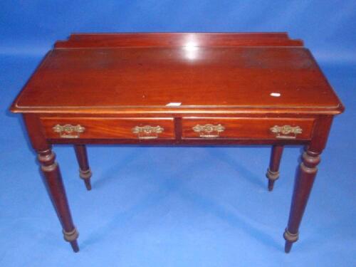 A Victorian mahogany side table with two drawers and turned legs