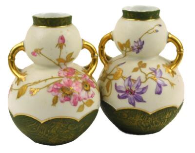 A pair of Continental porcelain two handled double gauge shaped vases