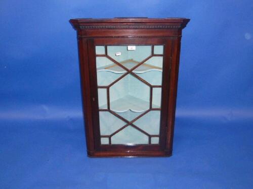 A Georgian style mahogany hanging corner cupboard with astragal glazed door