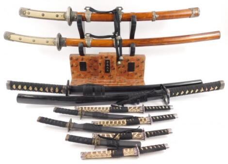 A collection of replica samurai swords daggers etc.