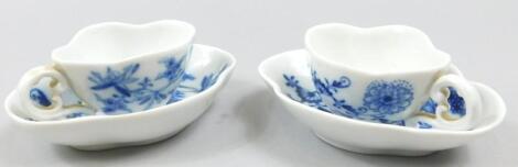 A pair of late Meissen Onion pattern blue and white small cabinet cups and saucers