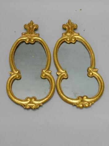 A pair of Continental cartouche shaped giltwood wall mirrors