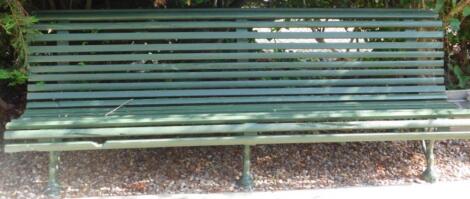 A large cast iron green painted park type bench