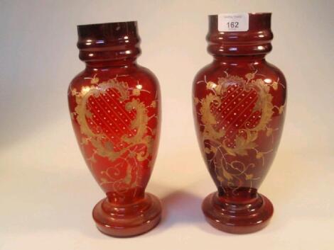 A pair of late 19thC cranberry glass ovoid vases