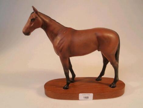 A Beswick figure of Mill Reef with matt chestnut coat on oval wooden base