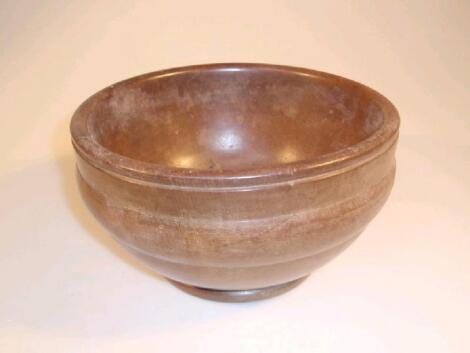 A 19thC polished walnut circular bowl with moulded girdle