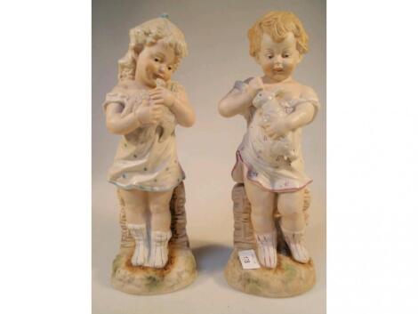 A pair of early 20thC German bisque figures modelled as a young girl with