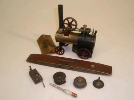 A Marples & Son mahogany and brass spirit level and a Bing model of a steam/vapour engine