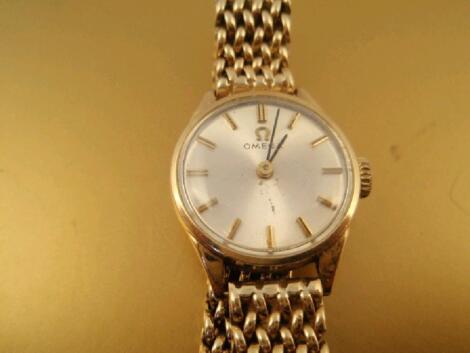 A ladies Omega round faced wristwatch with satin dial