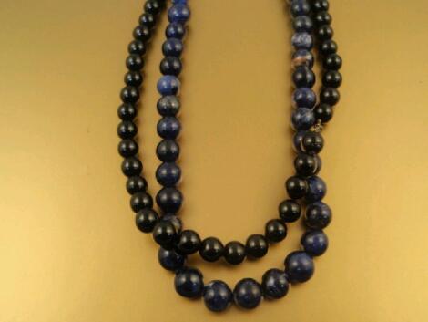 A sodalite bead necklace with matching stud screw back earrings and a black onyx set