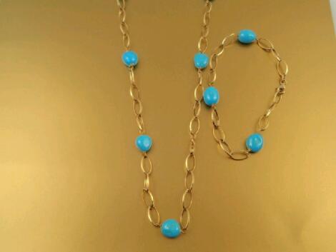 An open gold link and turquoise bead necklace