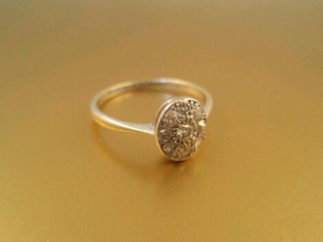 An Art Deco style oval head diamond set ring