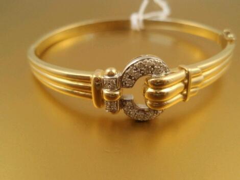 A hinged bangle with pav? diamond set buckle detail