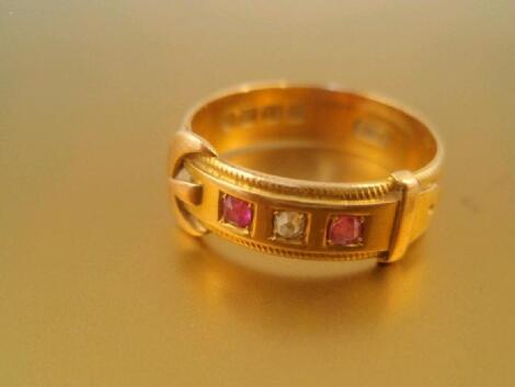 A Victorian 18ct gold buckle ring set with two tiny rubies and one diamond