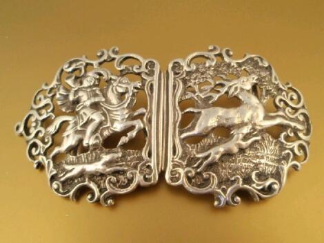 A continental nurses type belt buckle showing deer and huntsman