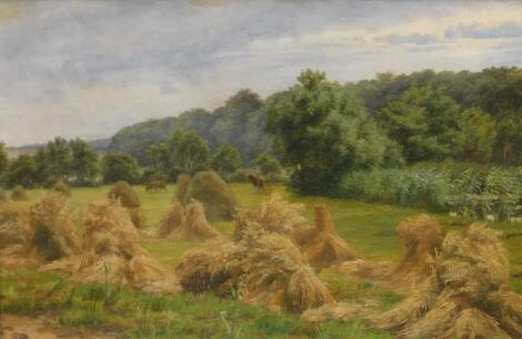 Louise Ravn-Hansen (1849-1909). Harvest field by a stream with wheatsheafs