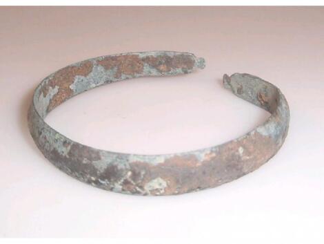 A late Roman flattened bronze open-ended bracelet with triangular-shaped terminals