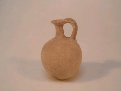 A small ancient pottery jug with a spherical body