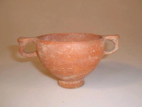 A Roman pottery two-handled cup or skyphos with two ring hands