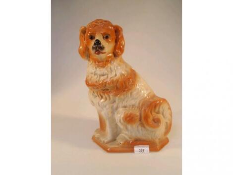 A late 19thC Staffordshire type seated spaniel with glass eyes