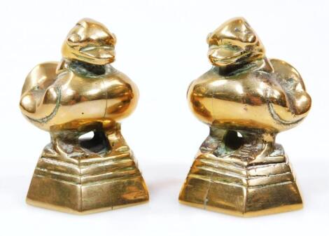 A pair of polished bronzed desk seals