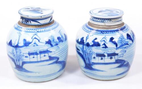 A pair of 18thC blue and white pottery jars and covers