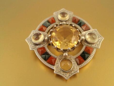 A Scottish circular shield brooch set with citrines and agates in white metal