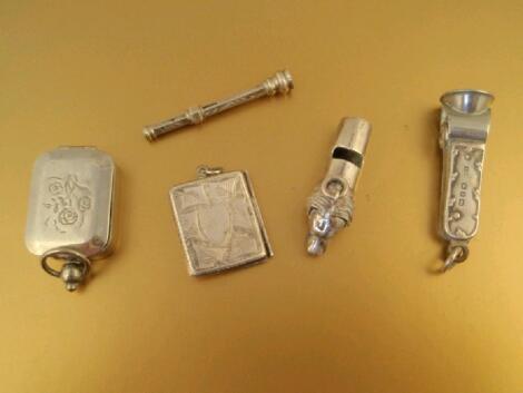 A silver stamp box, a silver smoking accessory and three small white metal trinket items