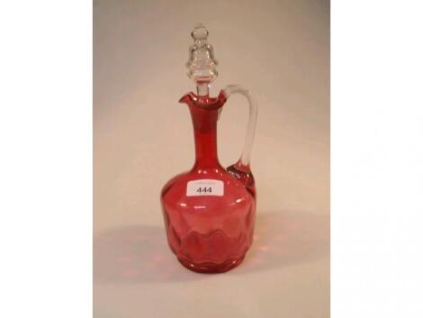 A Victorian cranberry glass ewer with clear glass stopper