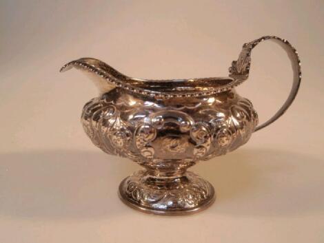 A George IV silver milk jug with gadroon border and acanthus C scroll handle