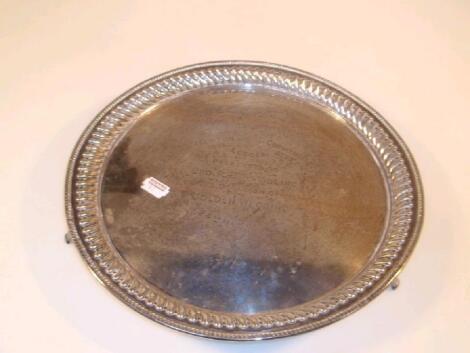 A late Victorian silver circular salver with raised gadroon border and Masonic inscription