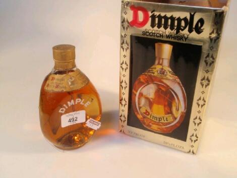 A Haig Dimple scotch whiskey bottle