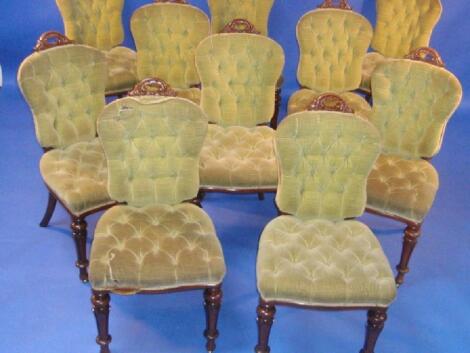 A set of ten Victorian mahogany dining chairs with carved scroll handle backs