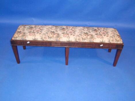 A 19thC mahogany window seat with drop in tapestry seat and square taper legs