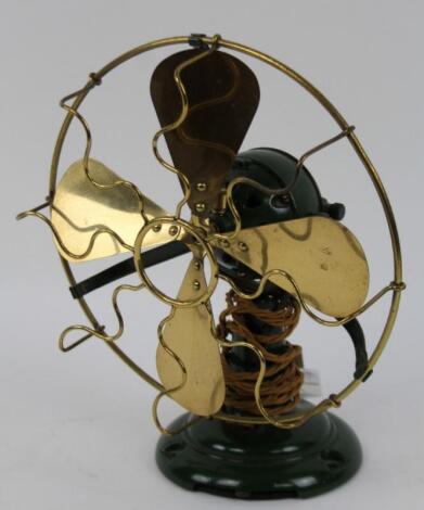 A 1930s style cast metal and brass desk fan