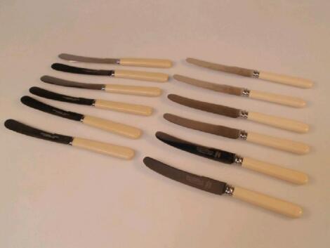 Two sets of six butter knives